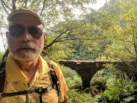 Old man and ancient aqueduct 