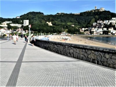 Broad sidewalk and wall next to beach